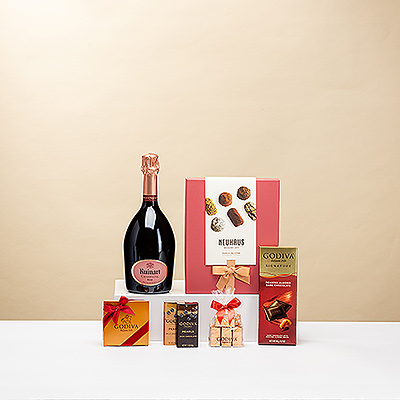 Choyez vos proches avec ce cadeau unique au champagne. Une bouteille prestigieuse de champagne Ruinart Rosé est présentée avec des truffes de luxe Neuhaus et du chocolat Godiva de première qualité.