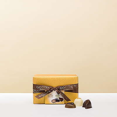 The classic and elegant Belgian ballotin wrapped in luxurious gold paper with a hand-tied ribbon contains a rich assortment of Godiva premium chocolates.